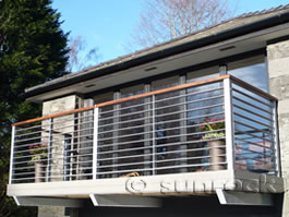 Balcony with steel slatted rails and hardwood handrail Lake District
